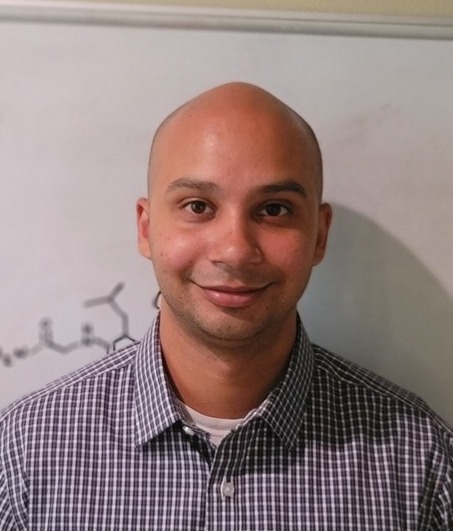 Michael Fernando, a light-skinned man smiling at the camera. 